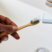toothpaste being squeezed onto toothpaste