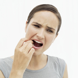 Woman feeling her tooth with her finger