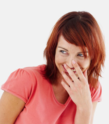 Woman laughing covering her mouth