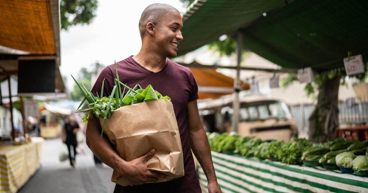 Man carrying grocery bag.