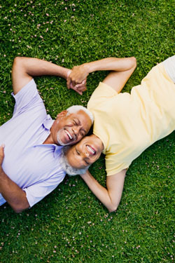 senior couple laying in grass