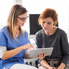 patient reviewing tablet with dentist