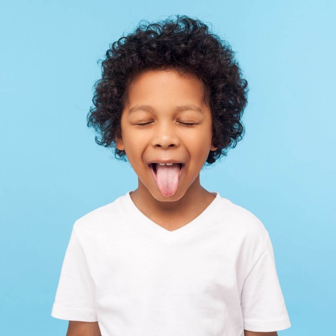 Child sticking tongue out.