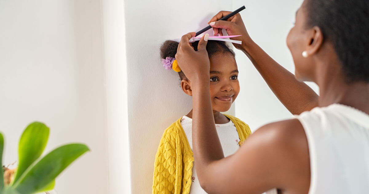 mom measuring daughter's height