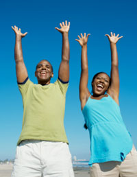 Man and woman holding their arms up in the air