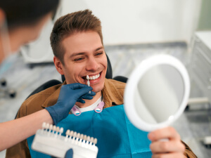 man during teeth whitening consultation at dentist