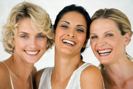Three woman with bright white smiles