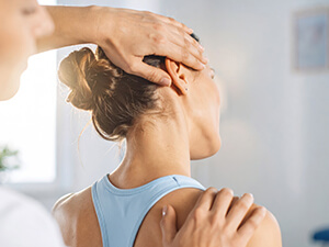 woman having her neck adjusted by a chiropractor