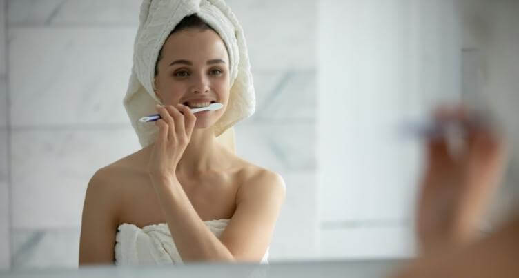 Woman brushing her teeth.