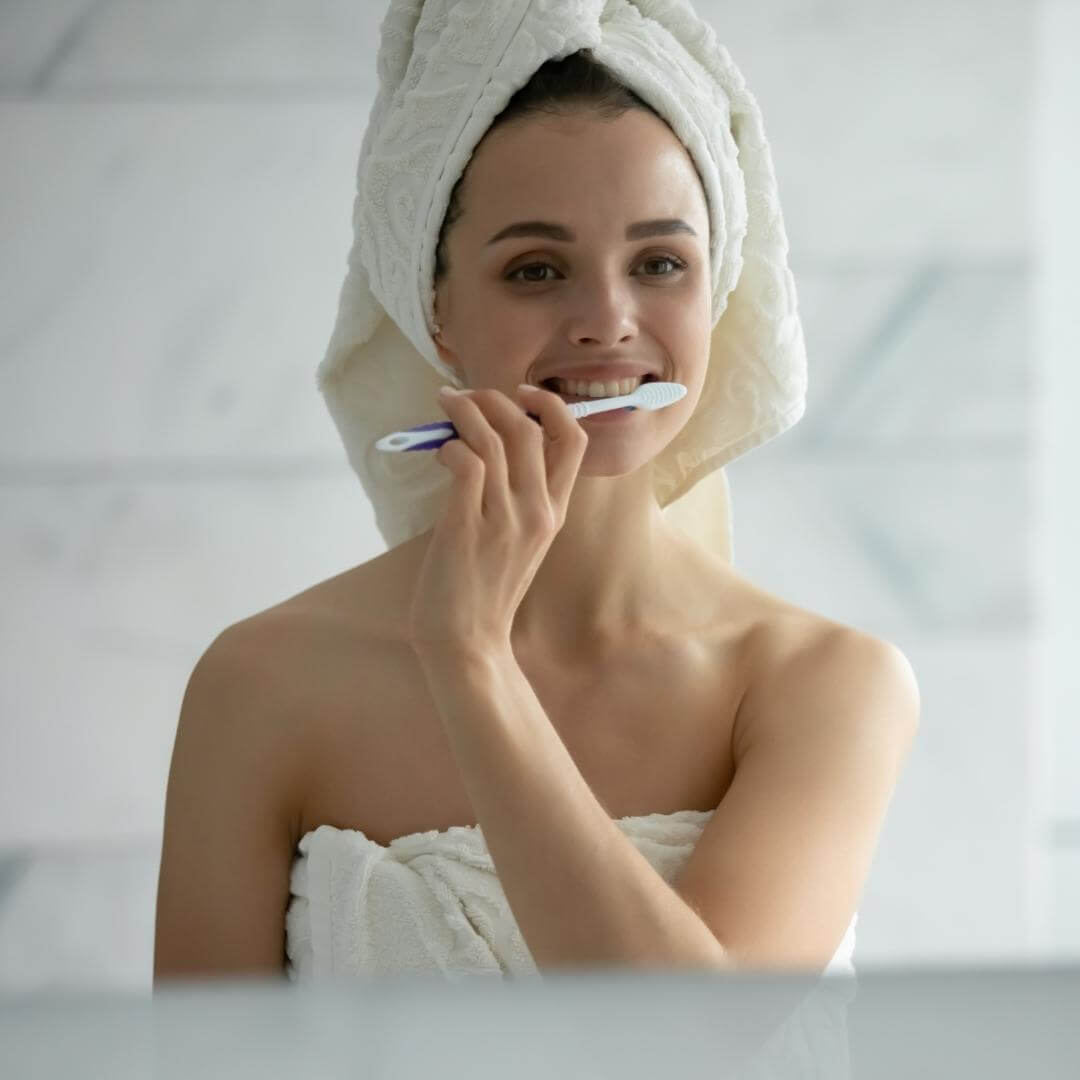 Woman brushing her teeth.