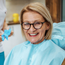 smiling woman in dentists chair