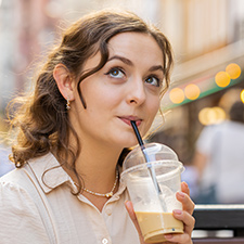 woman drinking iced coffee drink