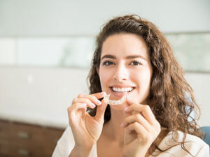 Woman beautiful holding aligner