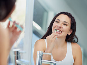 Woman brushing teeth