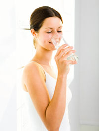Woman drinking from glass of water