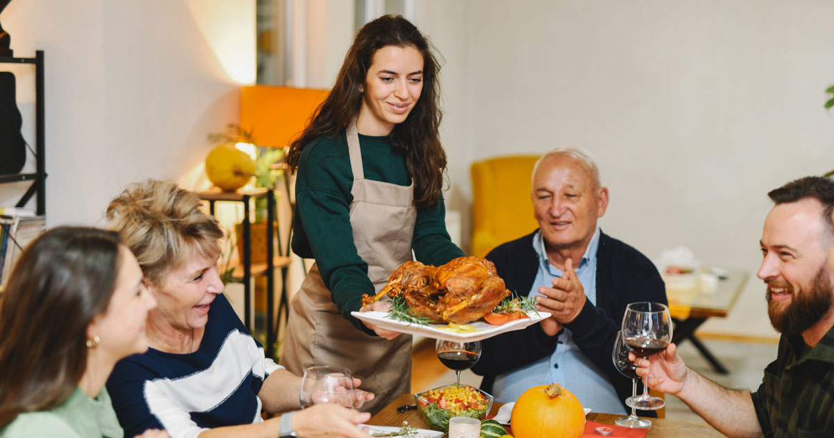 Woman holding turkey for family