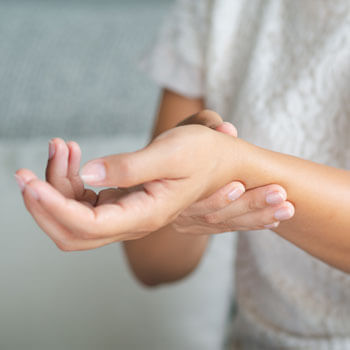 woman holding her wrist in pain