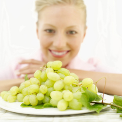 Woman with big plate of grapes