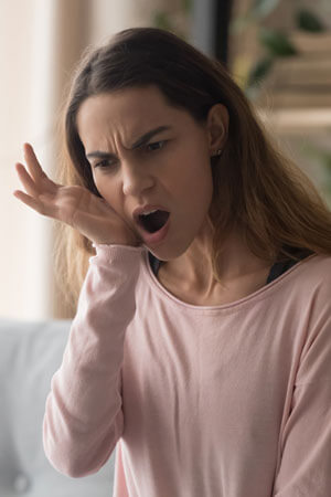 young woman touching painful jaw