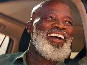 man looking in rearview mirror