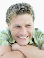 man with folded arms smiling