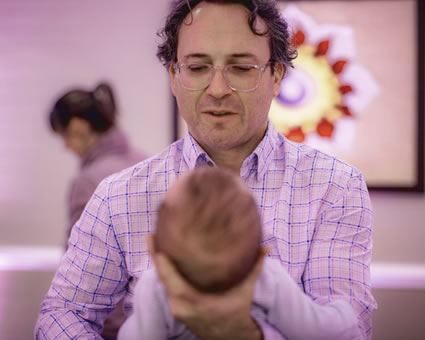 Dr. Wade Port adjusting an infant