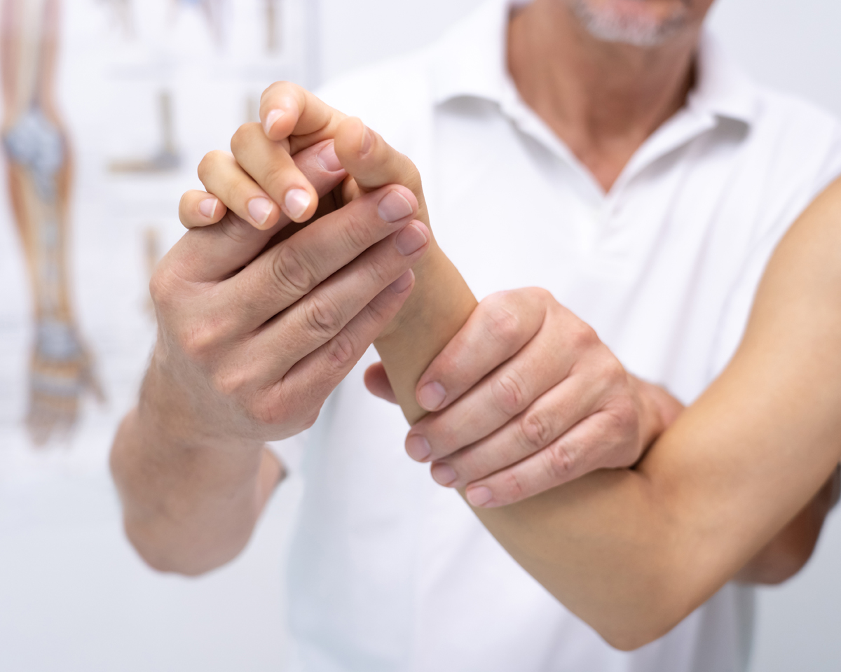 Chiropractor holding woman's hand