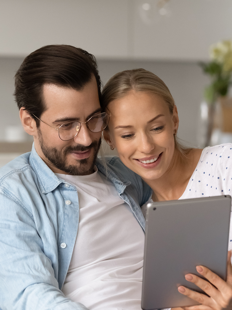 Couple holding tablet