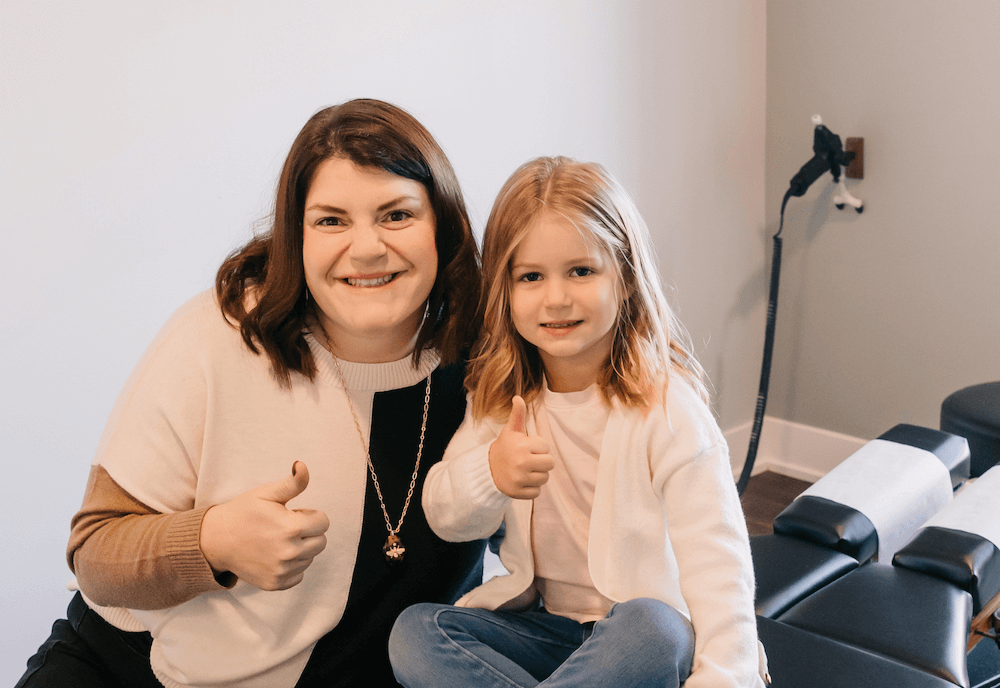 Dr. Krysti and child giving thumbs up