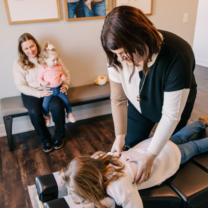 Krysti adjusting child on table