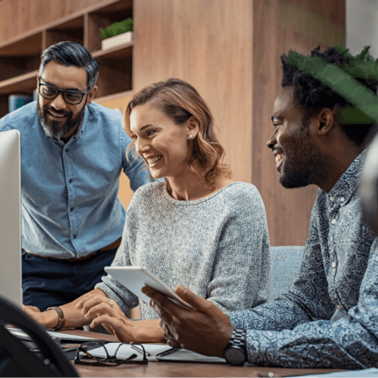 chiropractors sitting at a computer looking happy