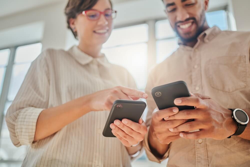 two people looking at their phones