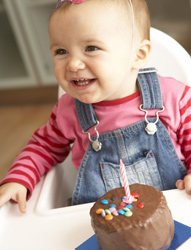 Baby with 1st birthday cupcake
