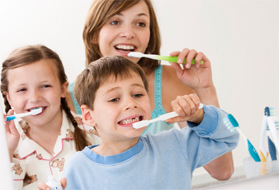 Family brushing their teeth together