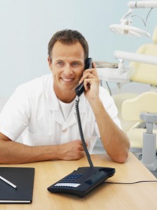 Smiling dentist on phone
