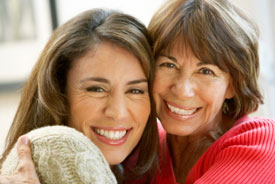 Mother and adult daughter hugging