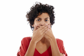 Woman covering her hands with her mouth