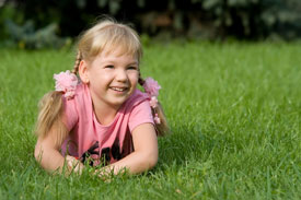 little girl in grass