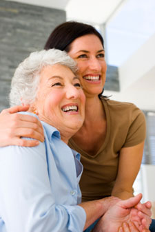 Daughter hugging elderly mother