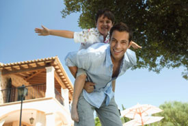 Man playing airplane with son