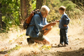 Grandfather and son on a hike. 