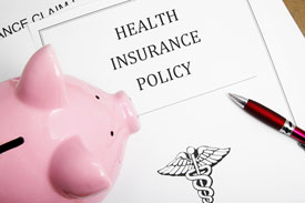 Health insurance page and piggy bank