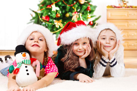 kids smiling under christmas tree