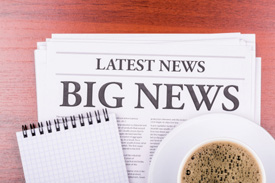 Newspaper, coffee and tablet on table