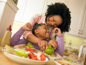 Mom and daughter preparing healthy food