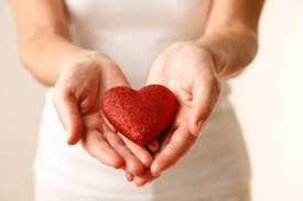 Woman holding a glittery heart