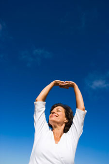 Woman with arms stretched upward