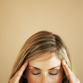 woman holding her temples