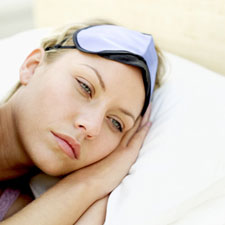 woman laying awake in bed