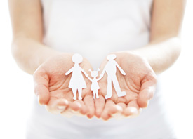 woman holding cutout of family